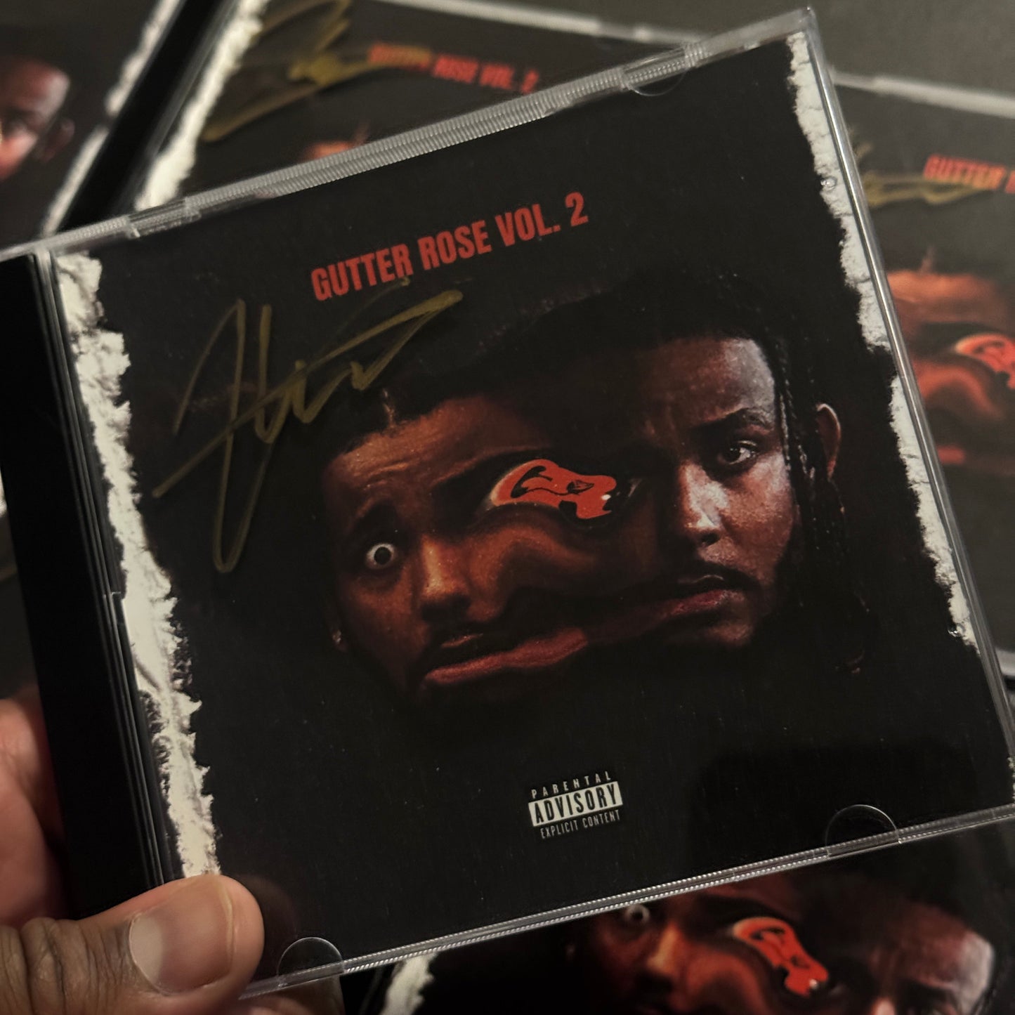 Close-up of a music album cover with a person's face and text on it.