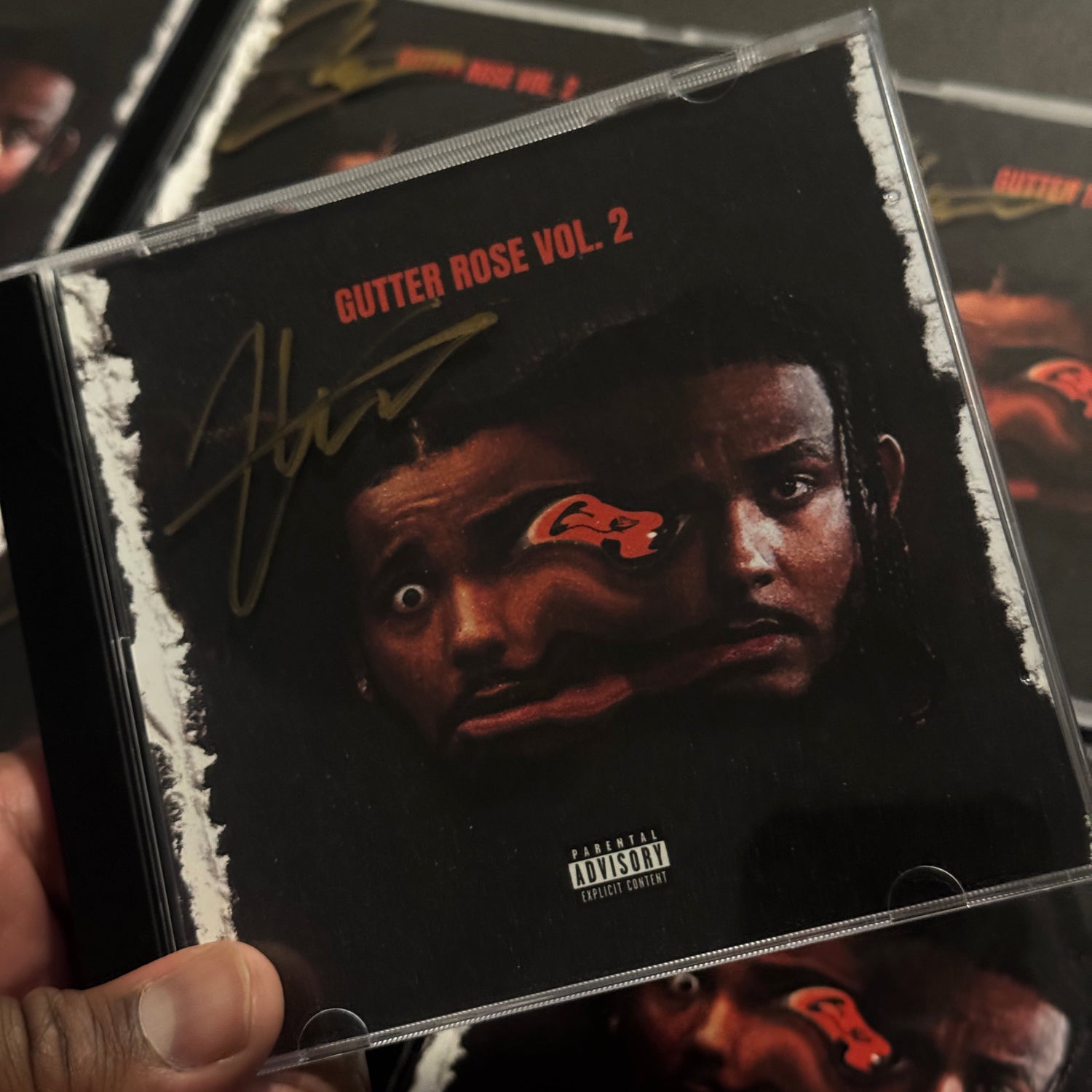 Close-up of a music album cover with a person's face and text on it.